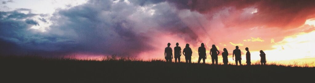 group of people on mountain at sunset, how to find a psychedelic community group